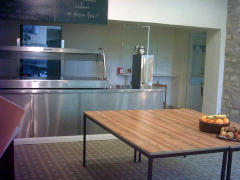 This area of the dining room is where to queue up to receive warm meals from the kitchen. The table will have fruit (shown here) and desserts on it. Food serving area